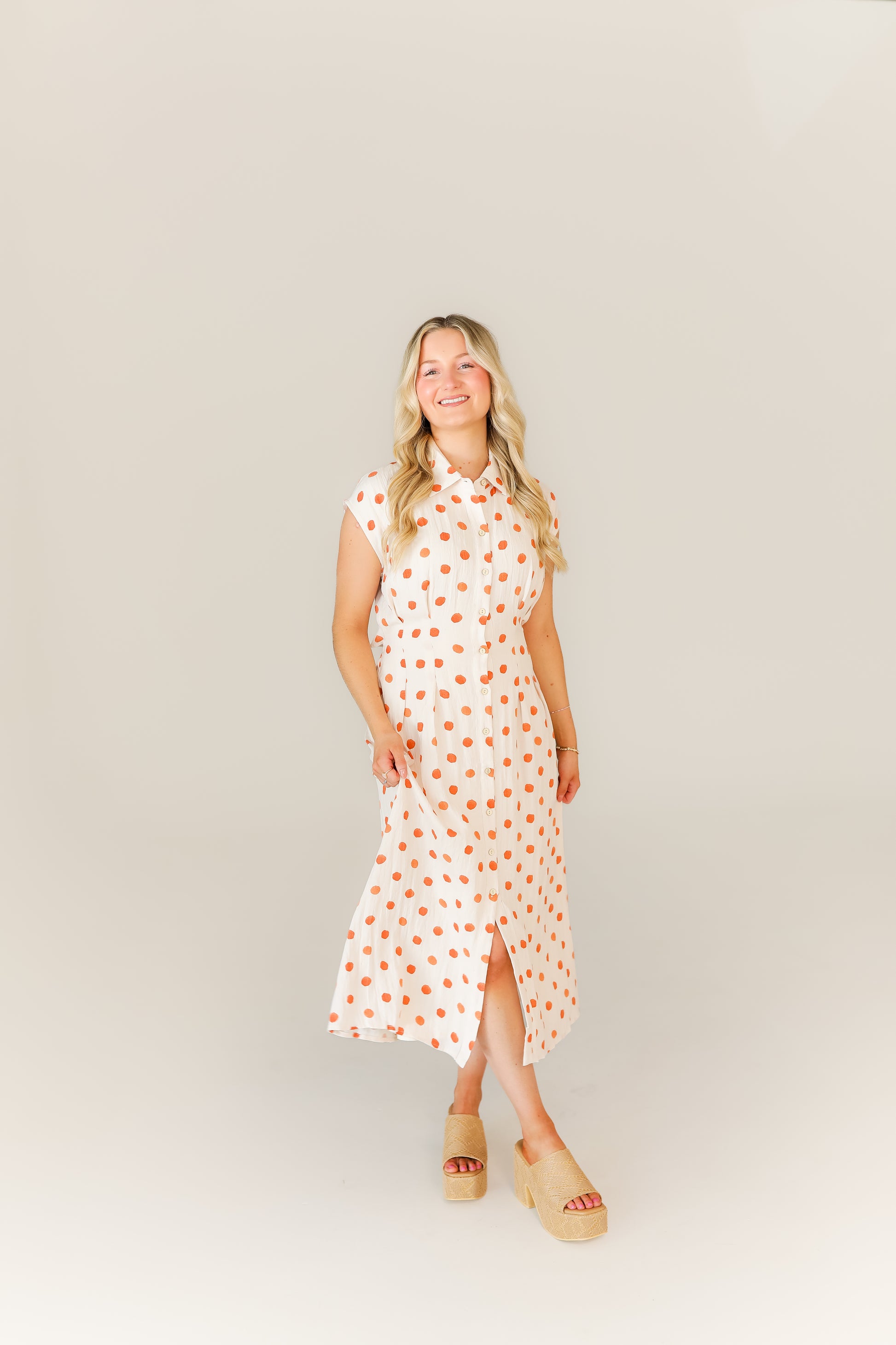 Flowy polka dot midi dress with sleeveless halter neckline