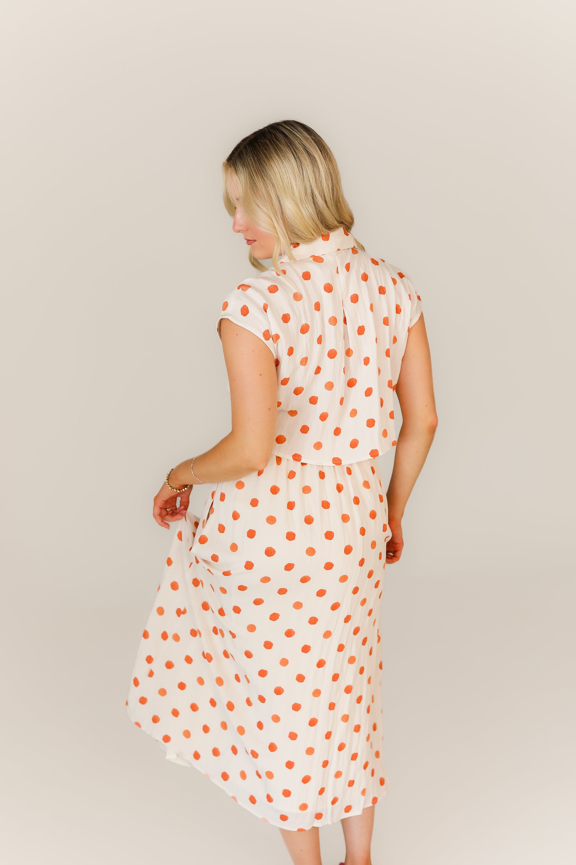 Back of white polka dot midi dress with halter neck style