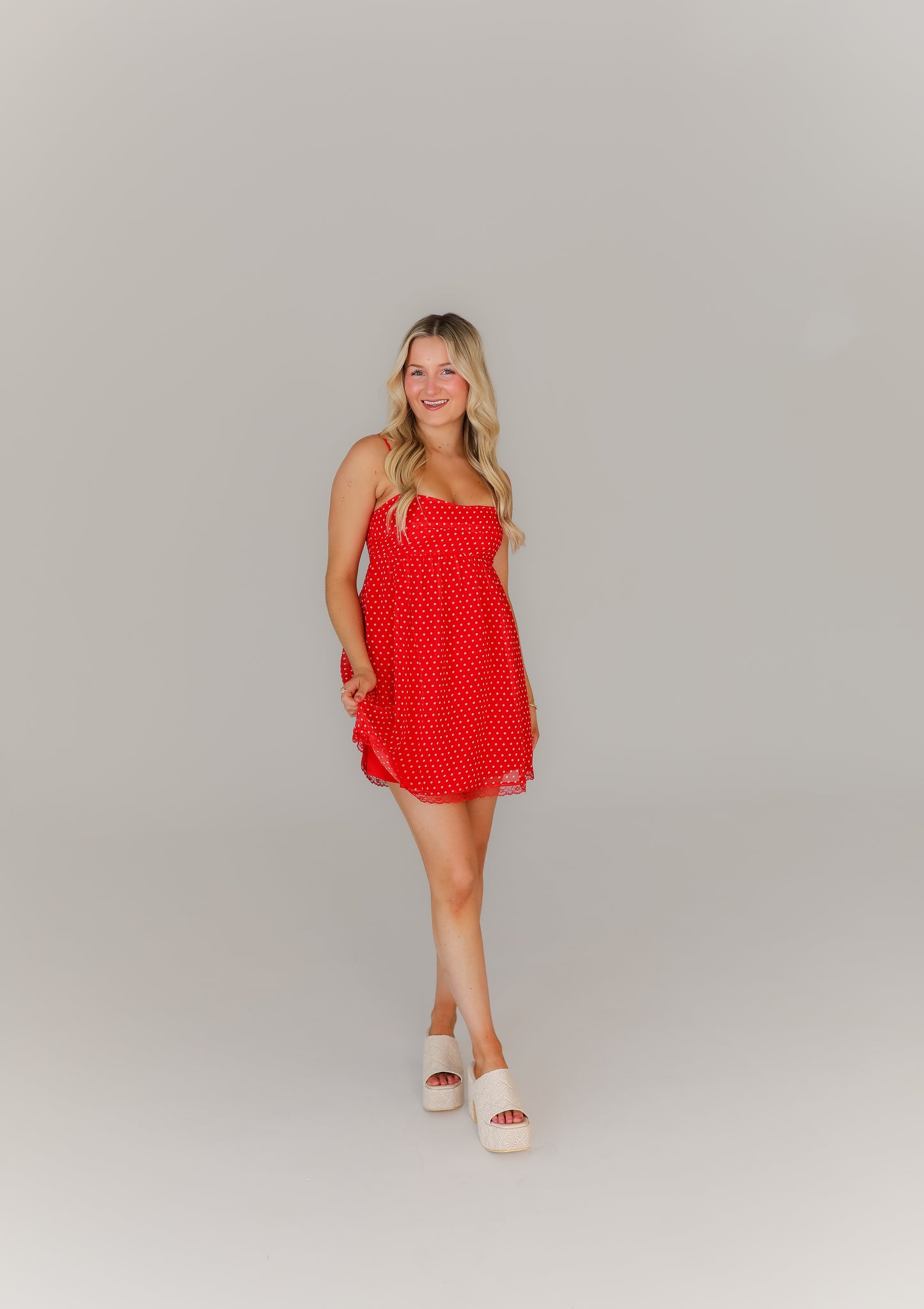 Women’s red polka dot mini dress with thin straps game day look