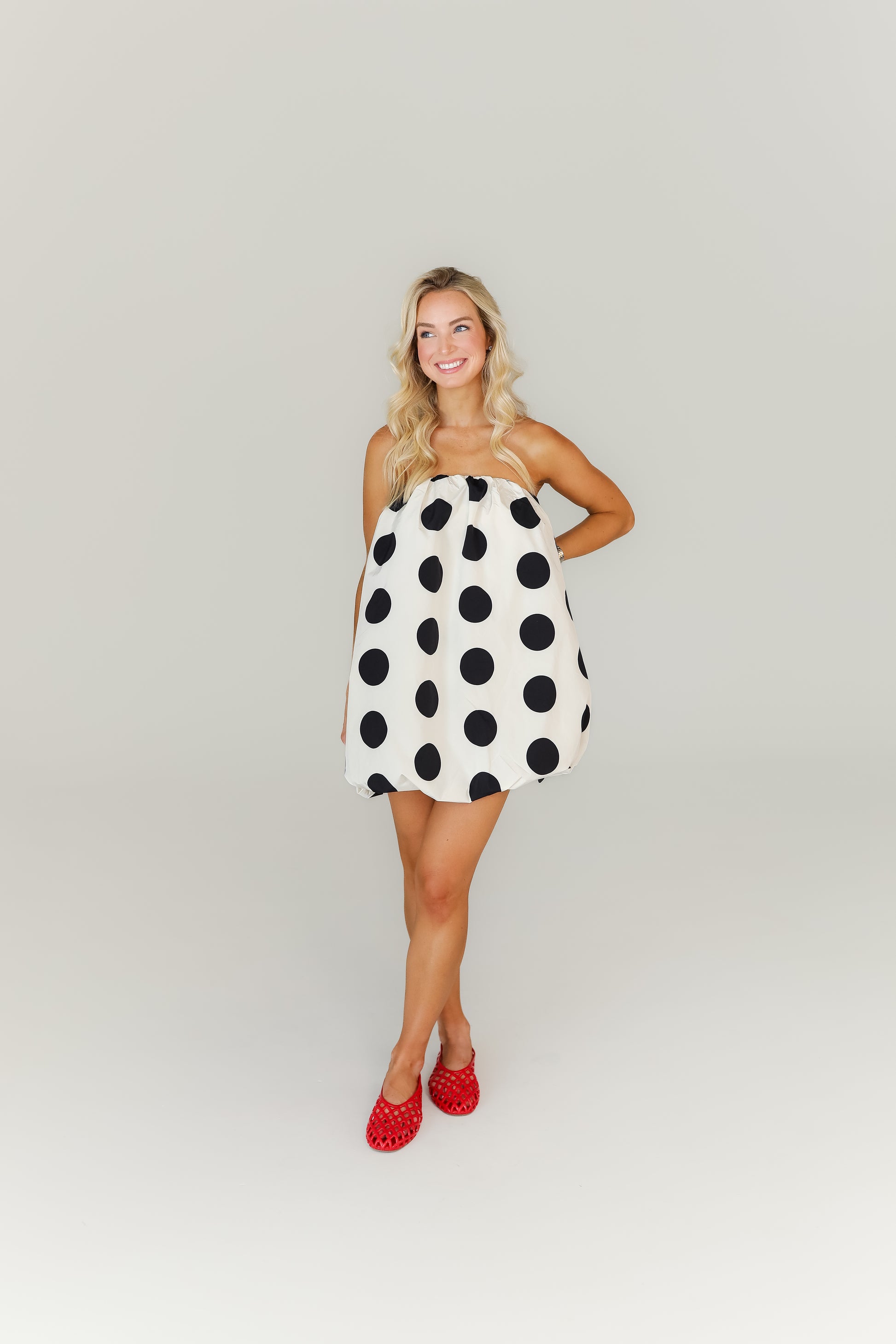 Black and white polka dot mini dress with bubble hem game day outfit