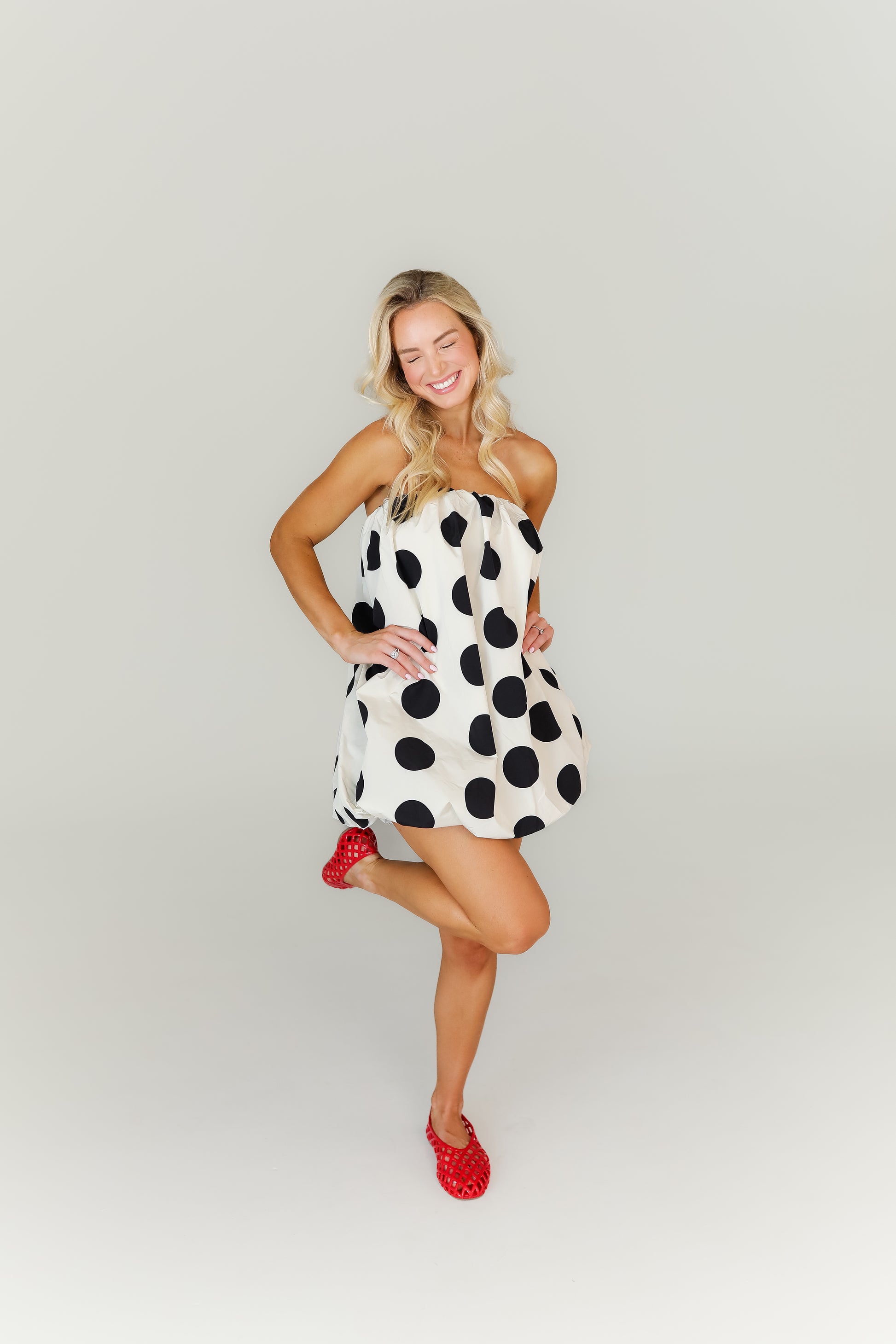 Bold polka dot strapless mini dress with bubble skirt hemline