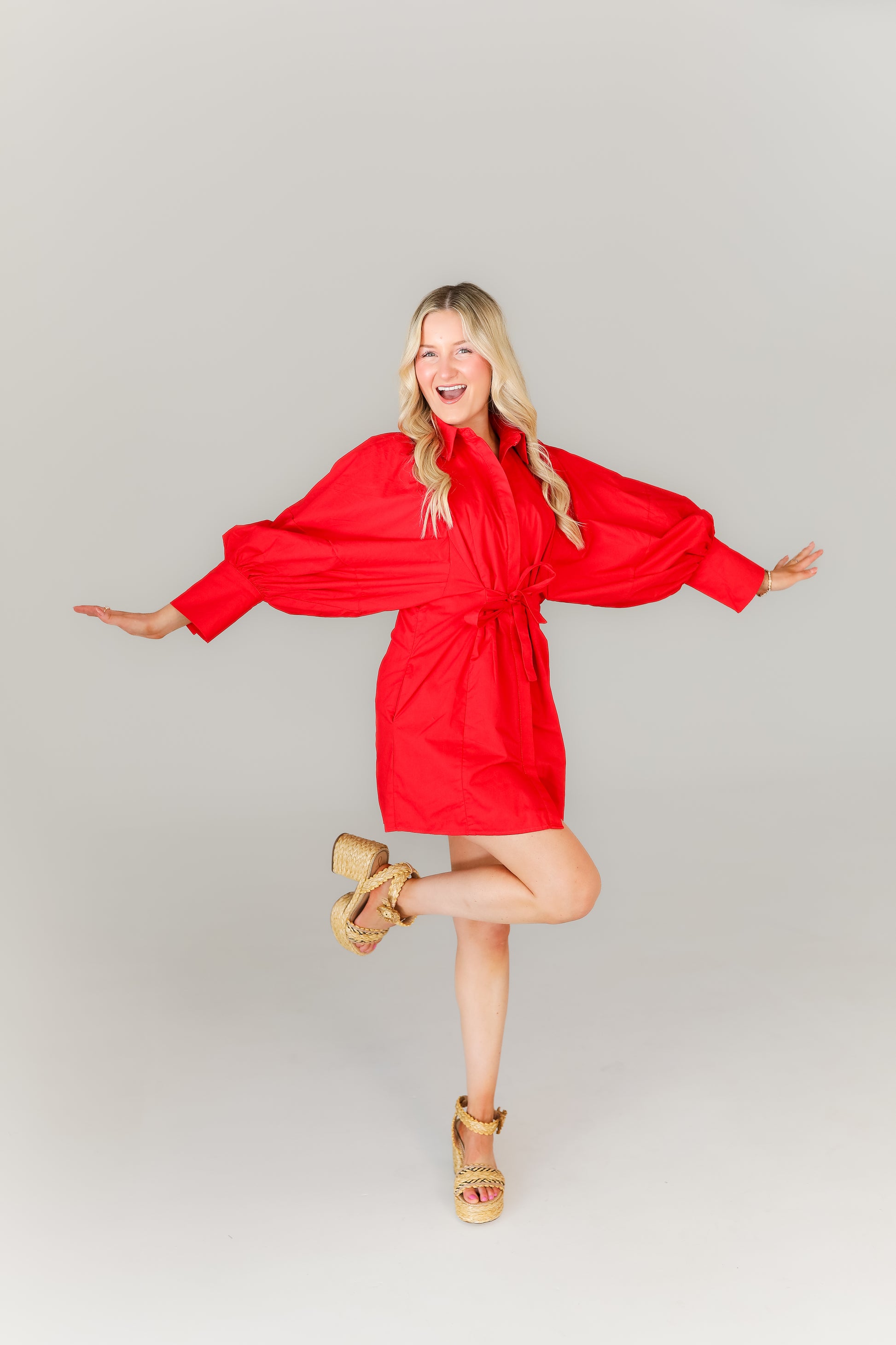Women’s red mini dress with tie waist and statement sleeves