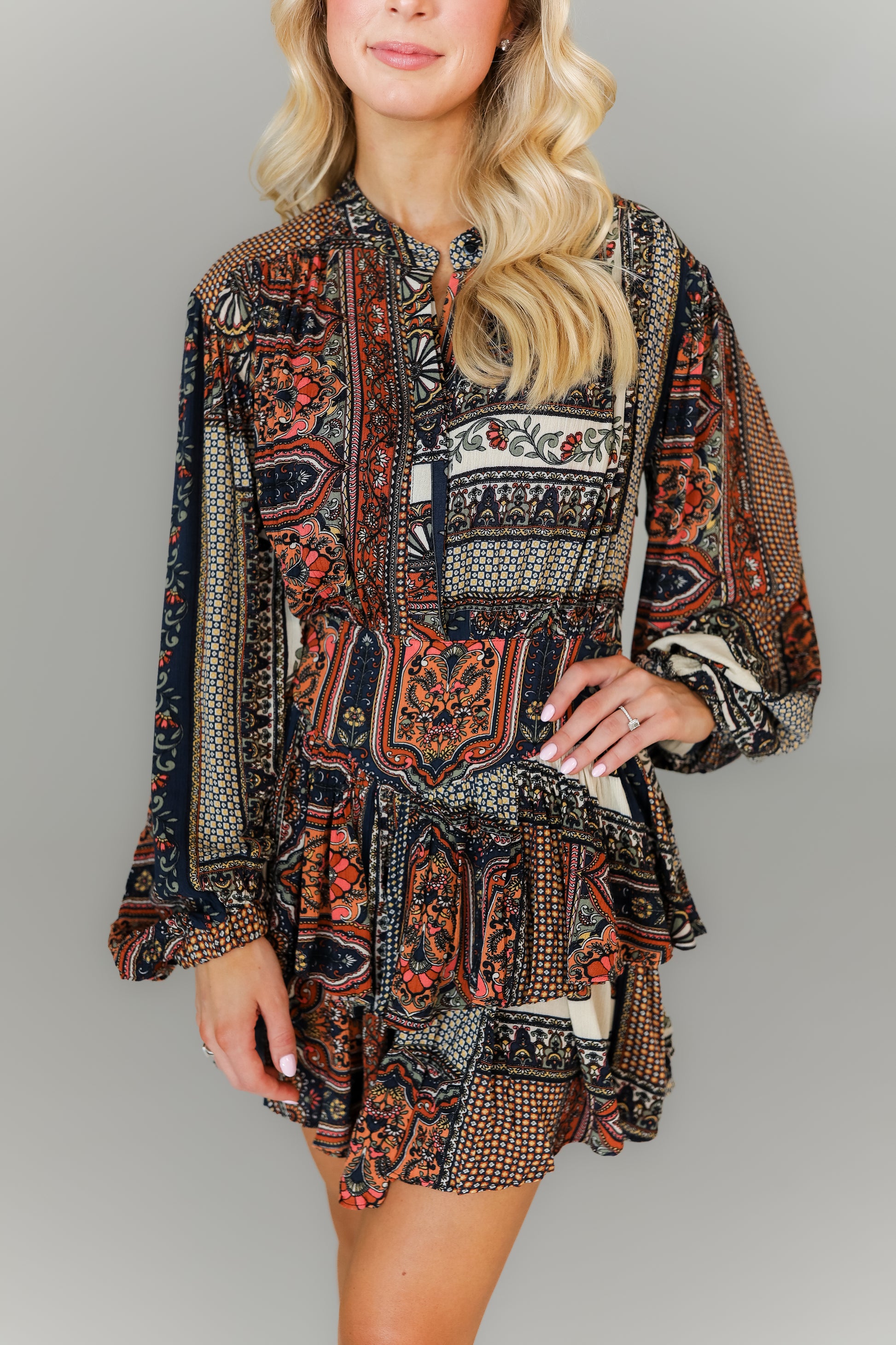 Detail of paisley print long sleeve mini dress with ruffle hem