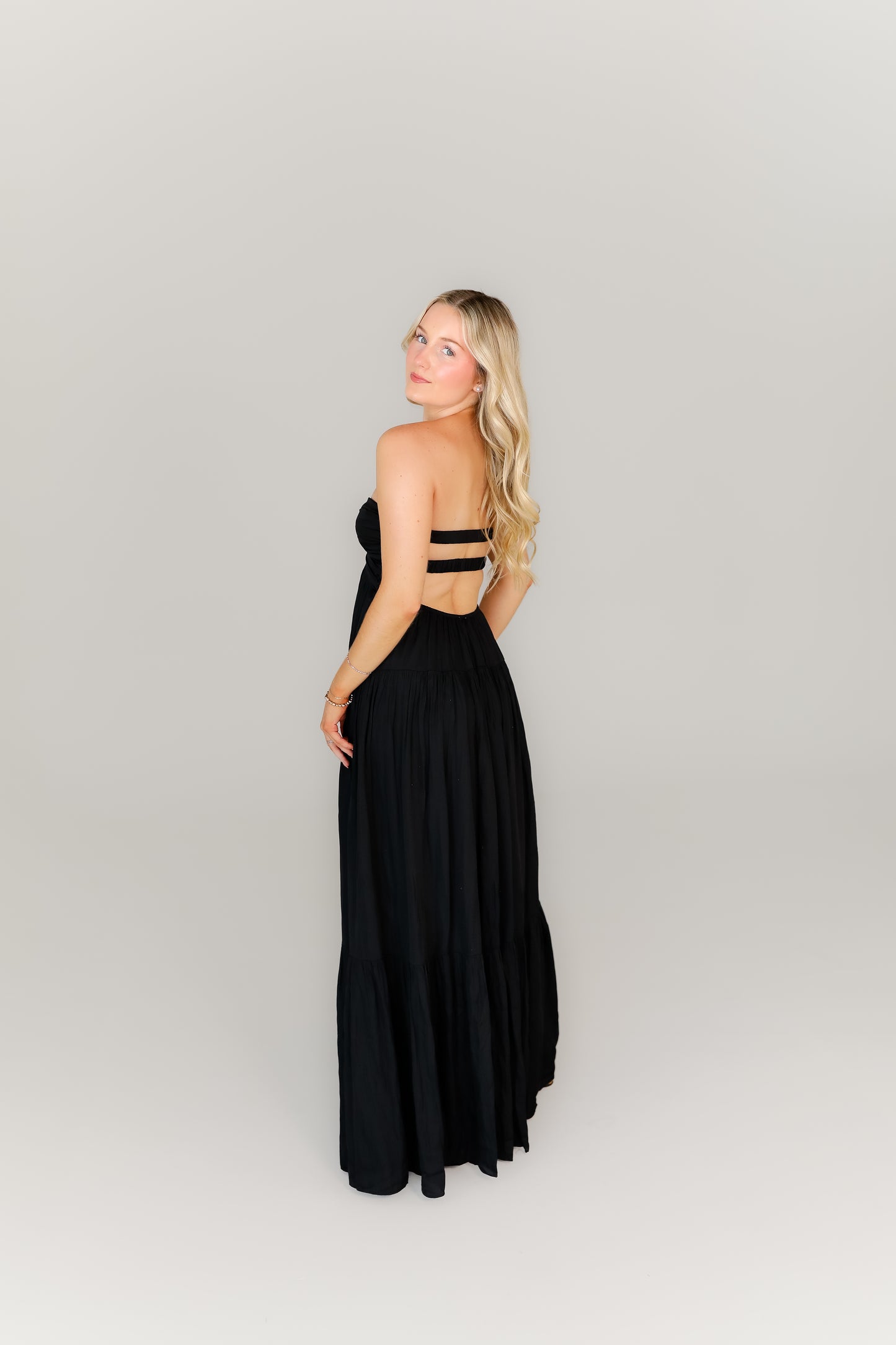 Strappy black dress with a sweetheart neckline styled with heels