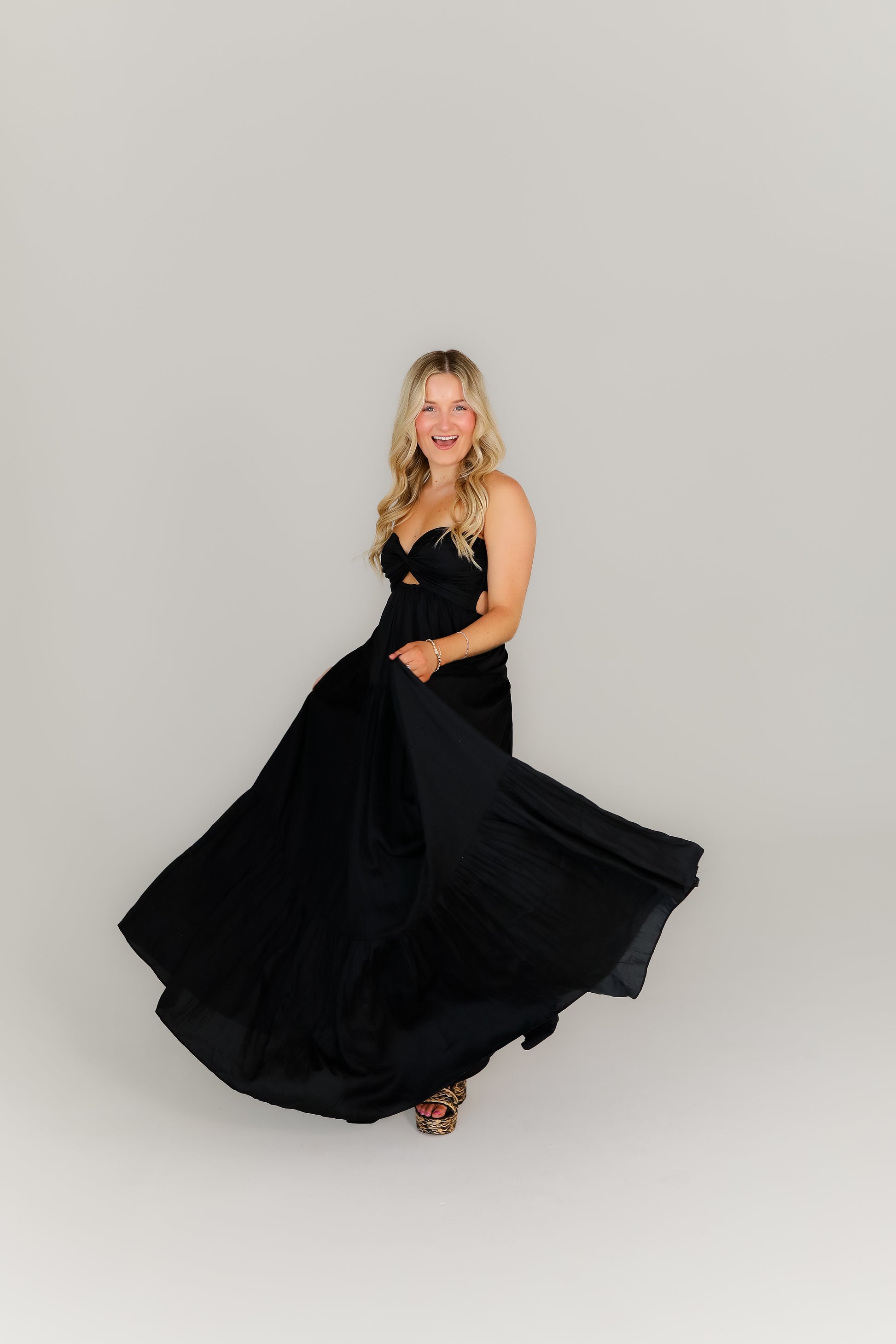 Strappy black dress with a sweetheart neckline styled with heels