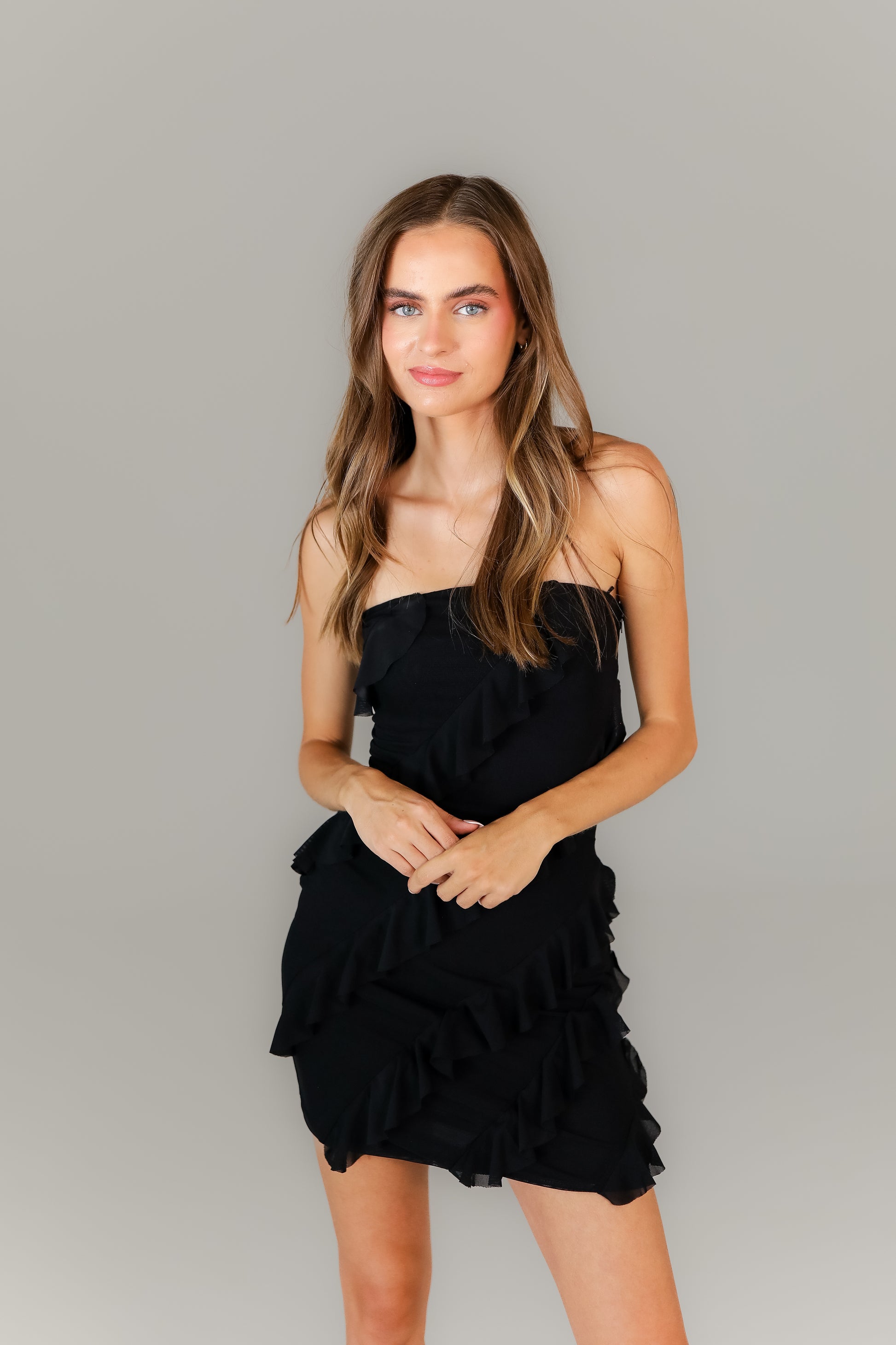 Boutique strapless black mini dress styled for night out