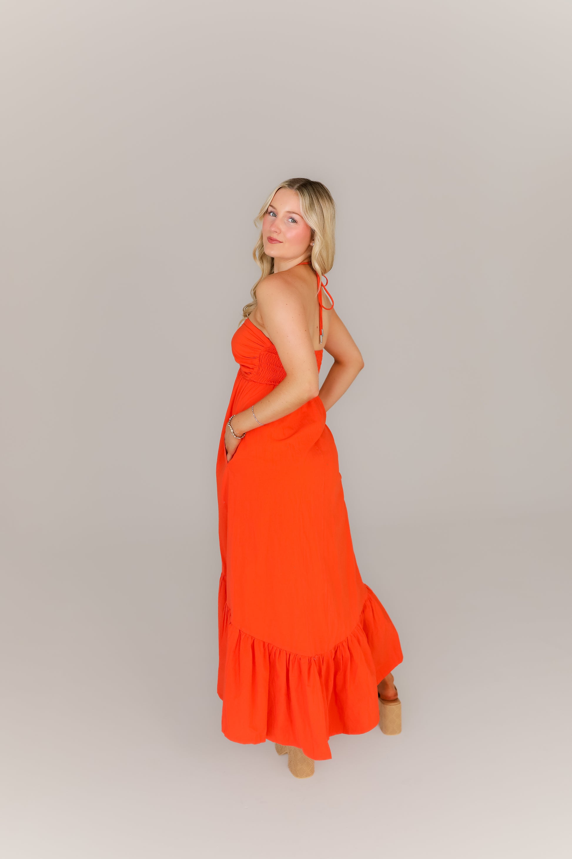 Flowy orange midi dress with pockets styled for game day