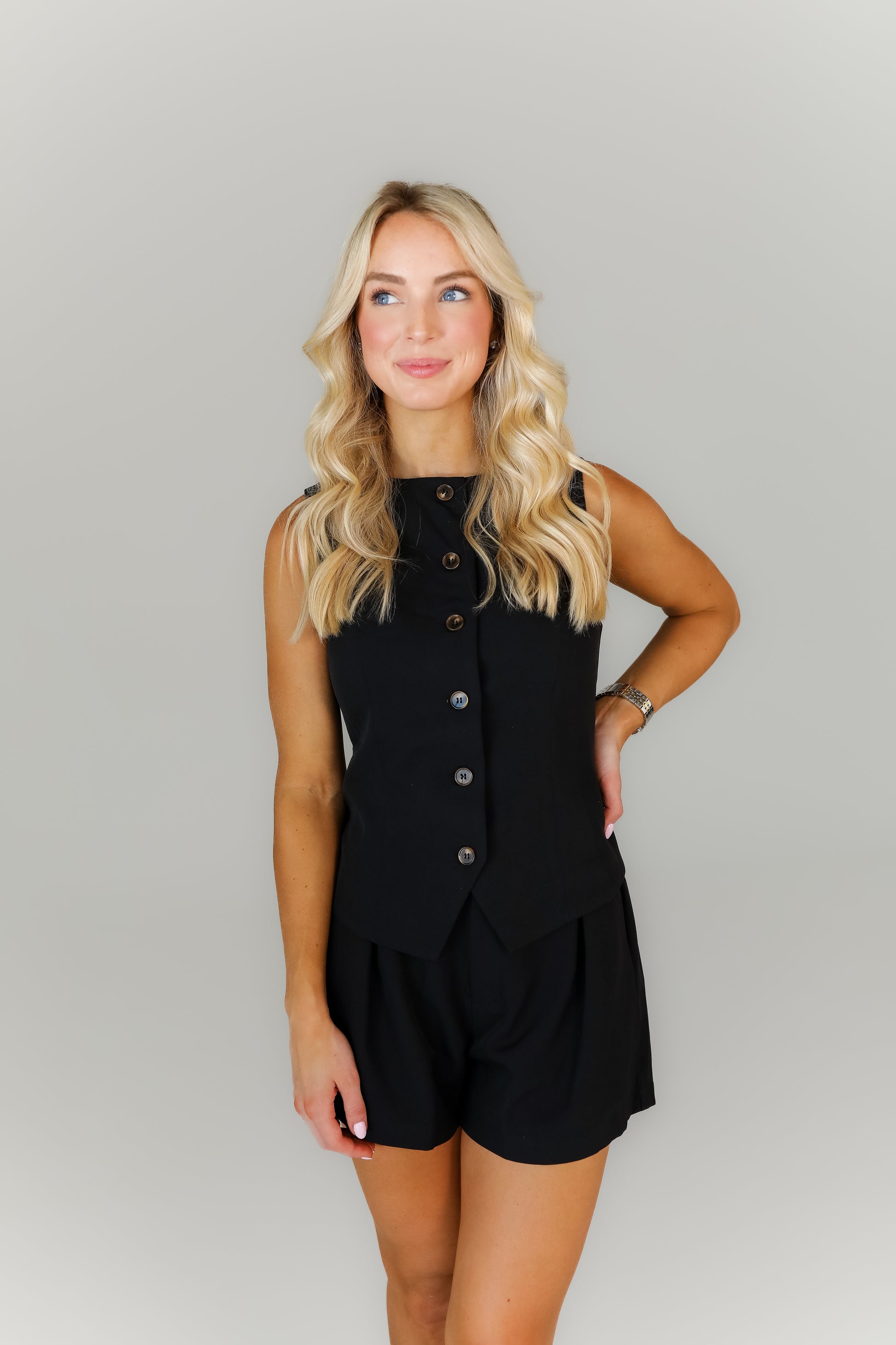 Chic black boutique set with button-front top and high-waisted shorts