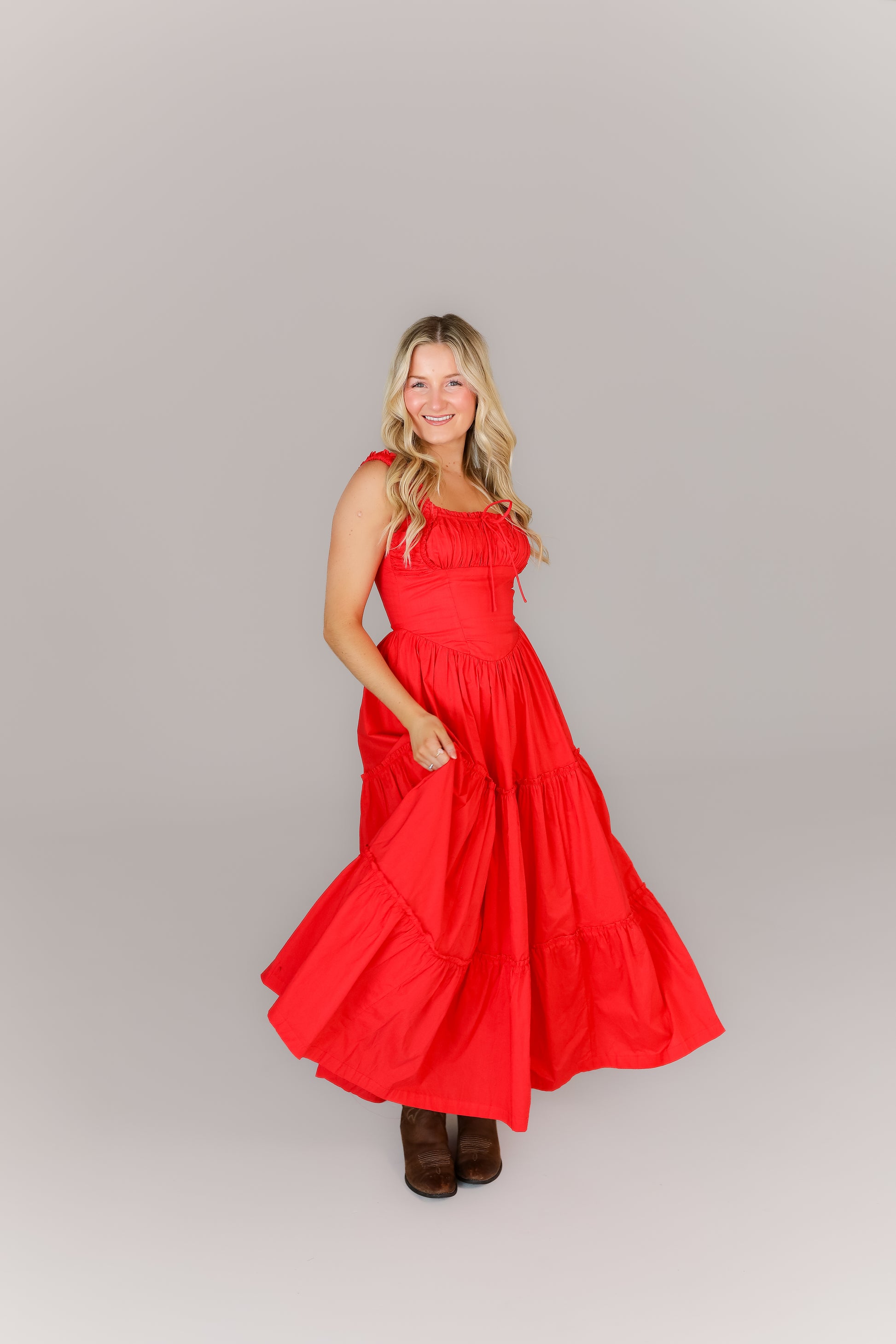 Front view of red smocked midi dress with square neckline & corset top