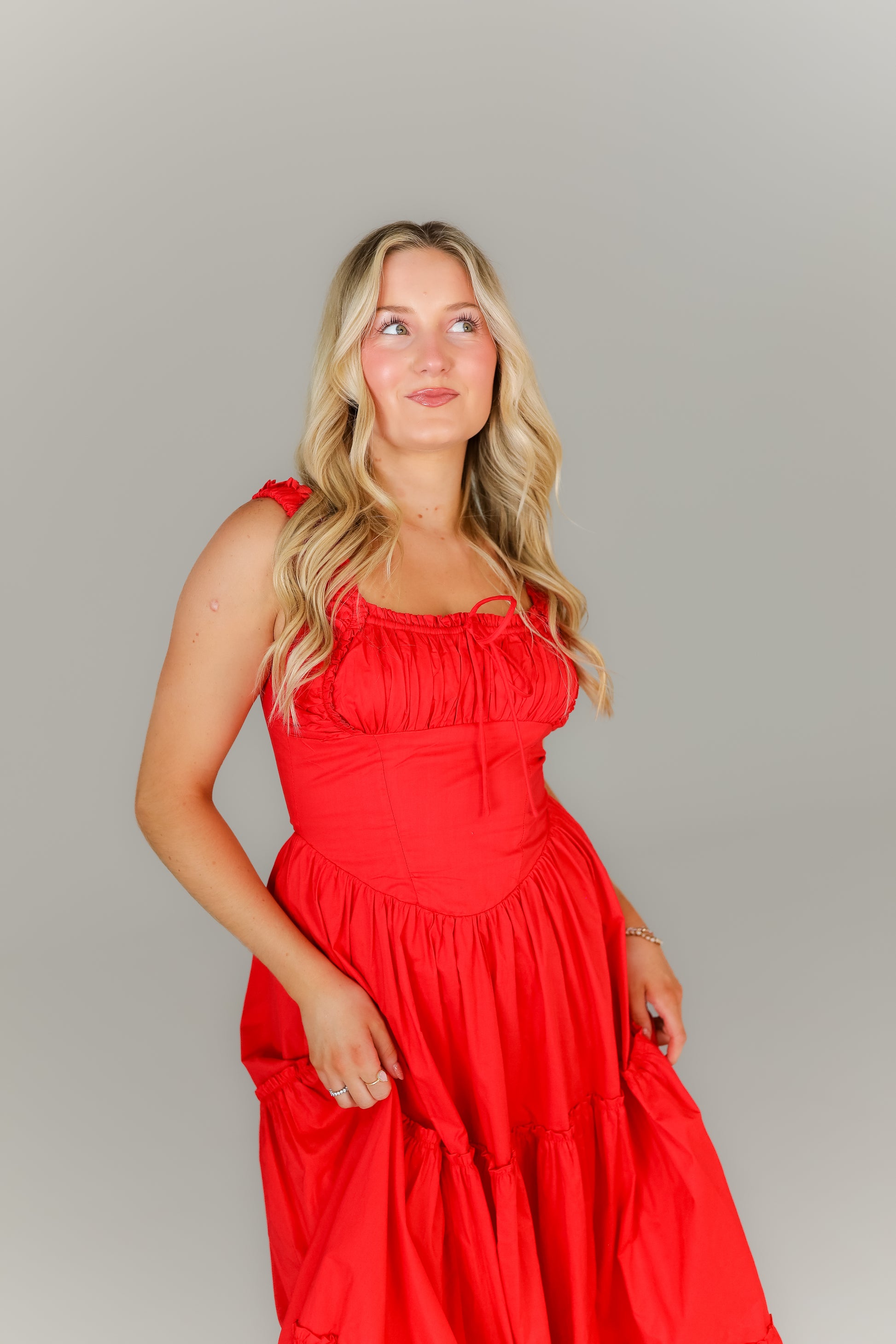 Close up of corset top half & ruched bust bright red boutique dress
