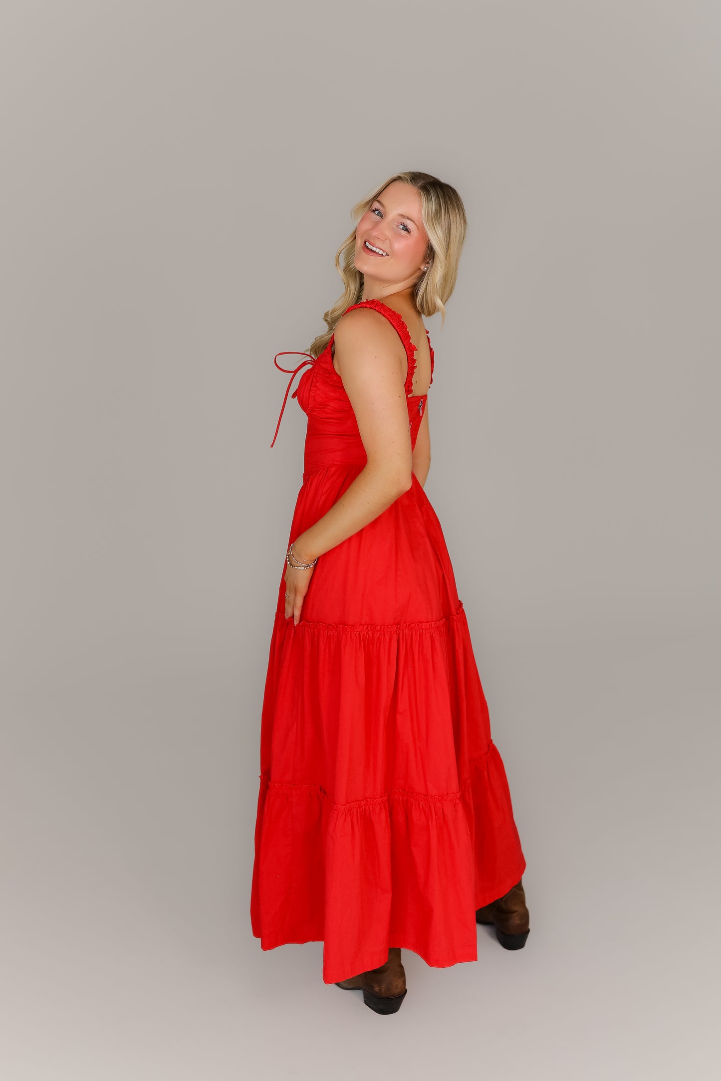 Back view of red tiered midi boutique dress with tiered skirt