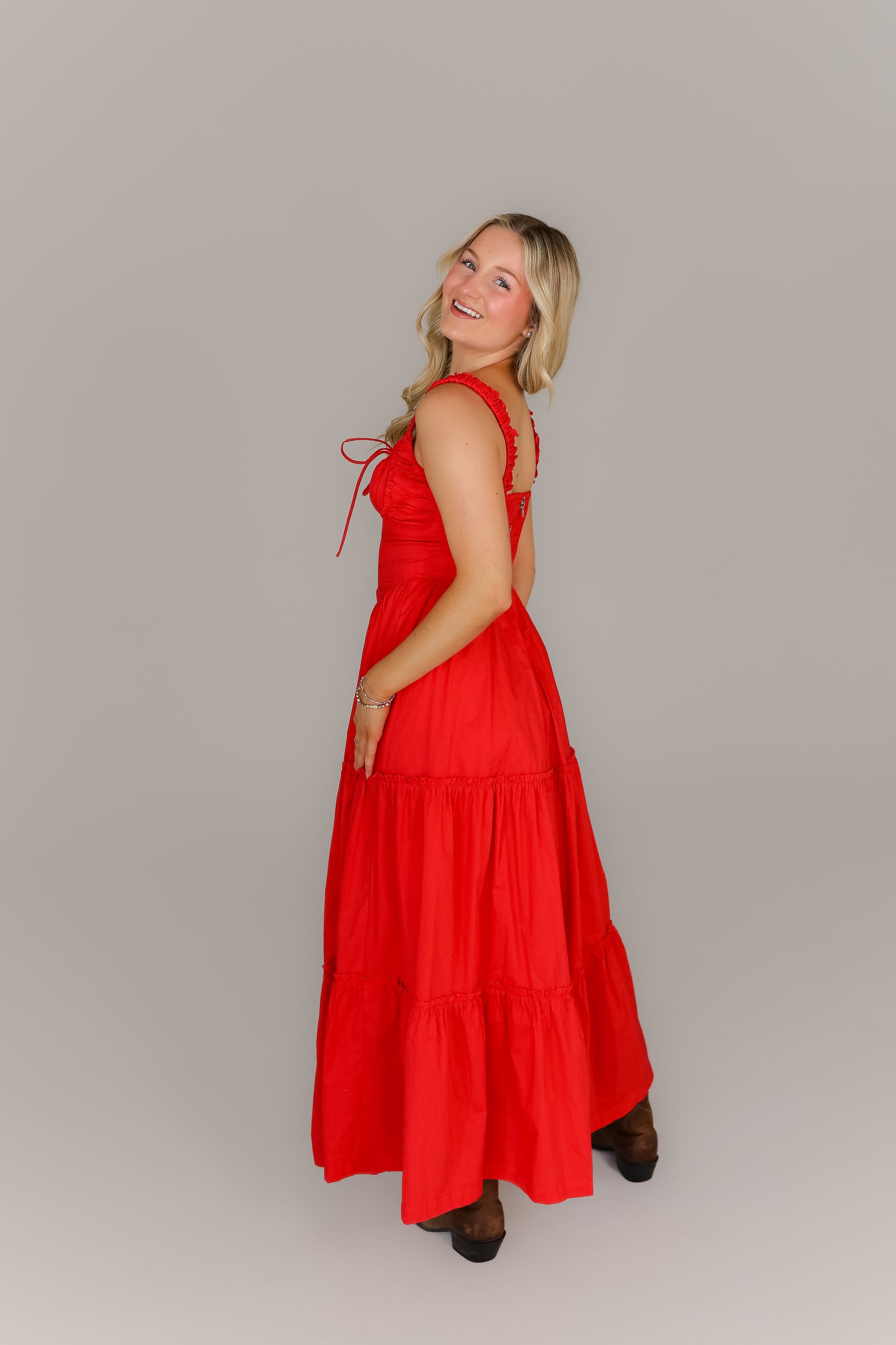 Back view of red tiered midi boutique dress with tiered skirt