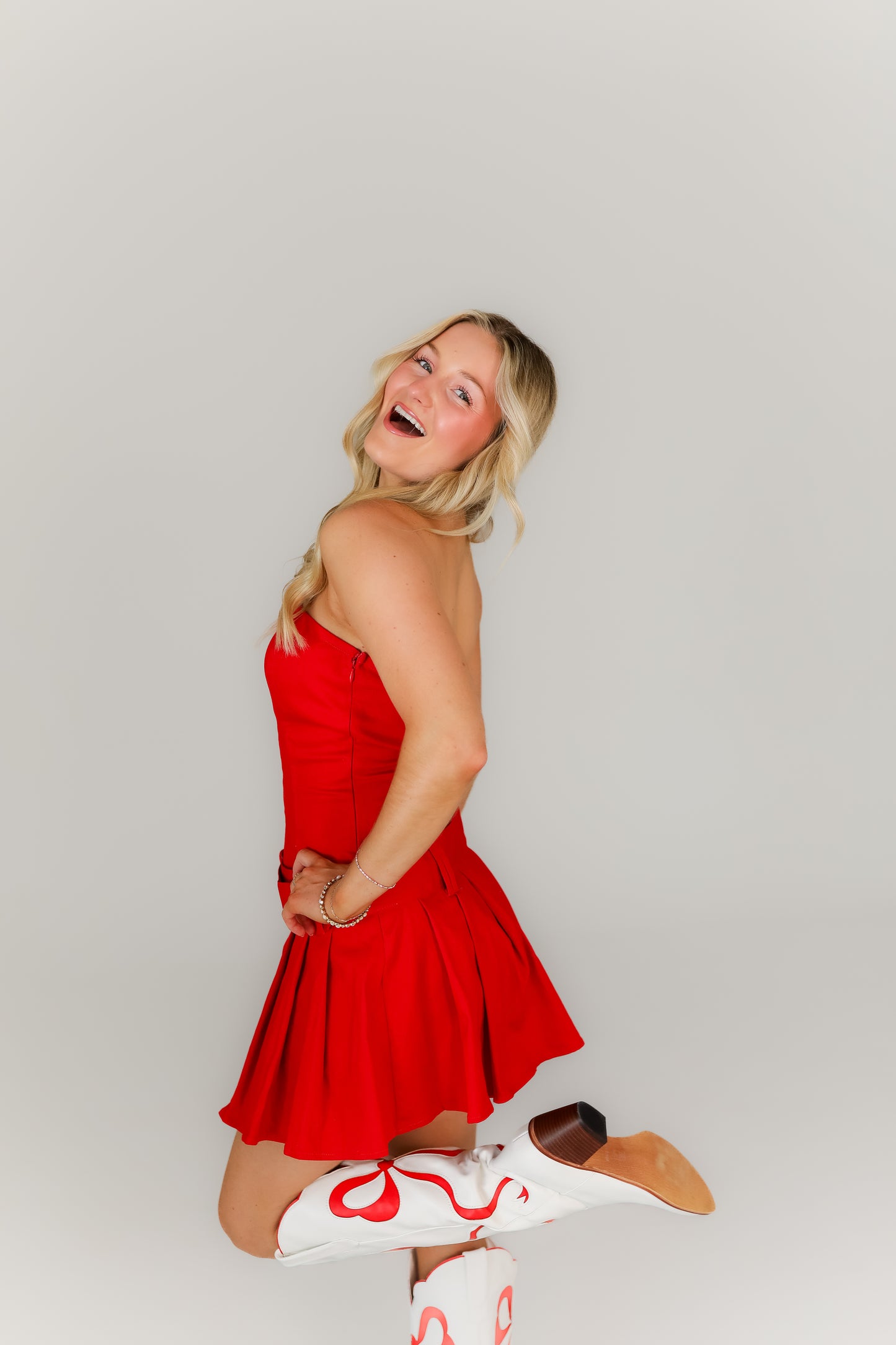 Bright red boutique mini dress with drop waist with belt perfect for gameday