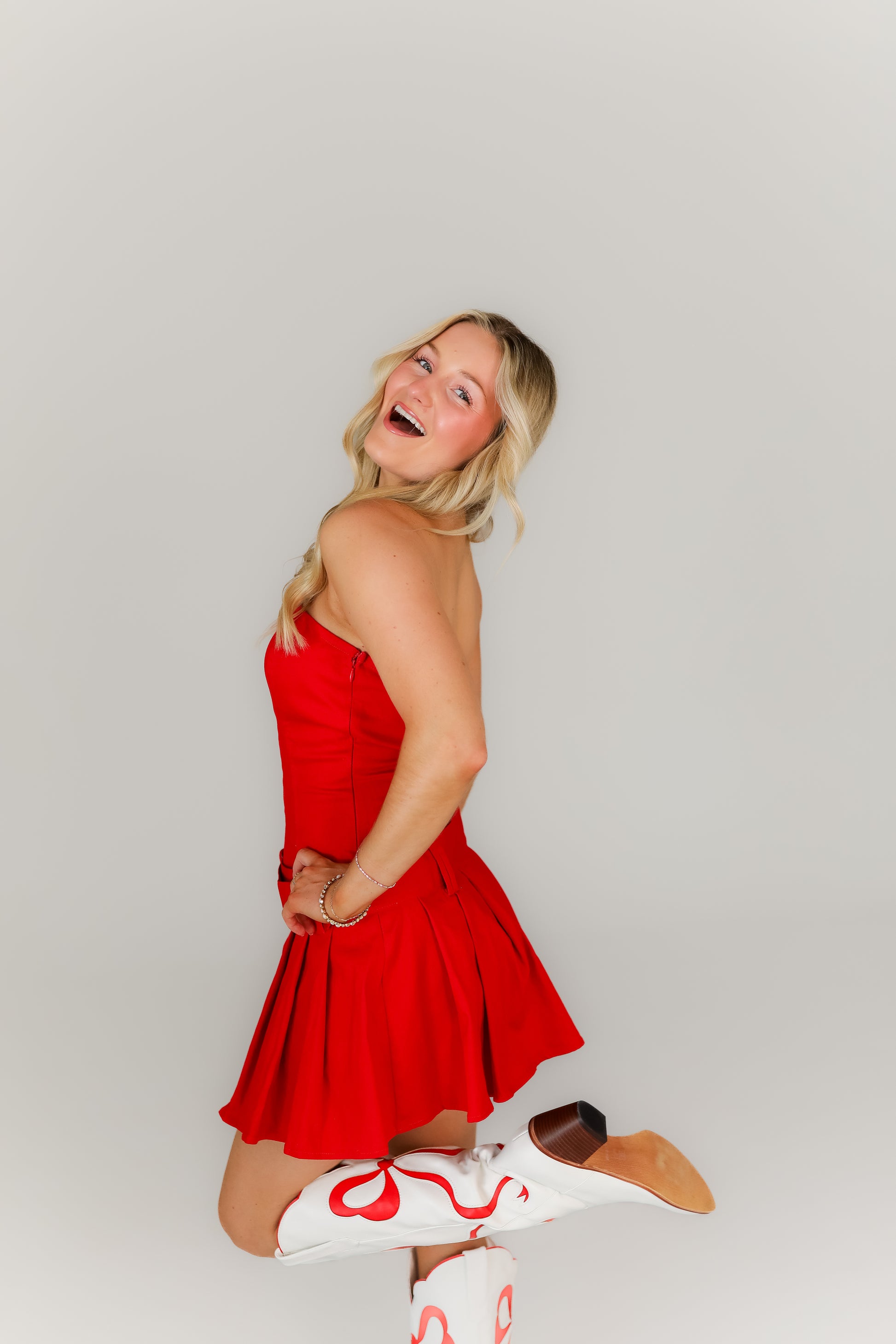 Bright red boutique mini dress with drop waist with belt perfect for gameday