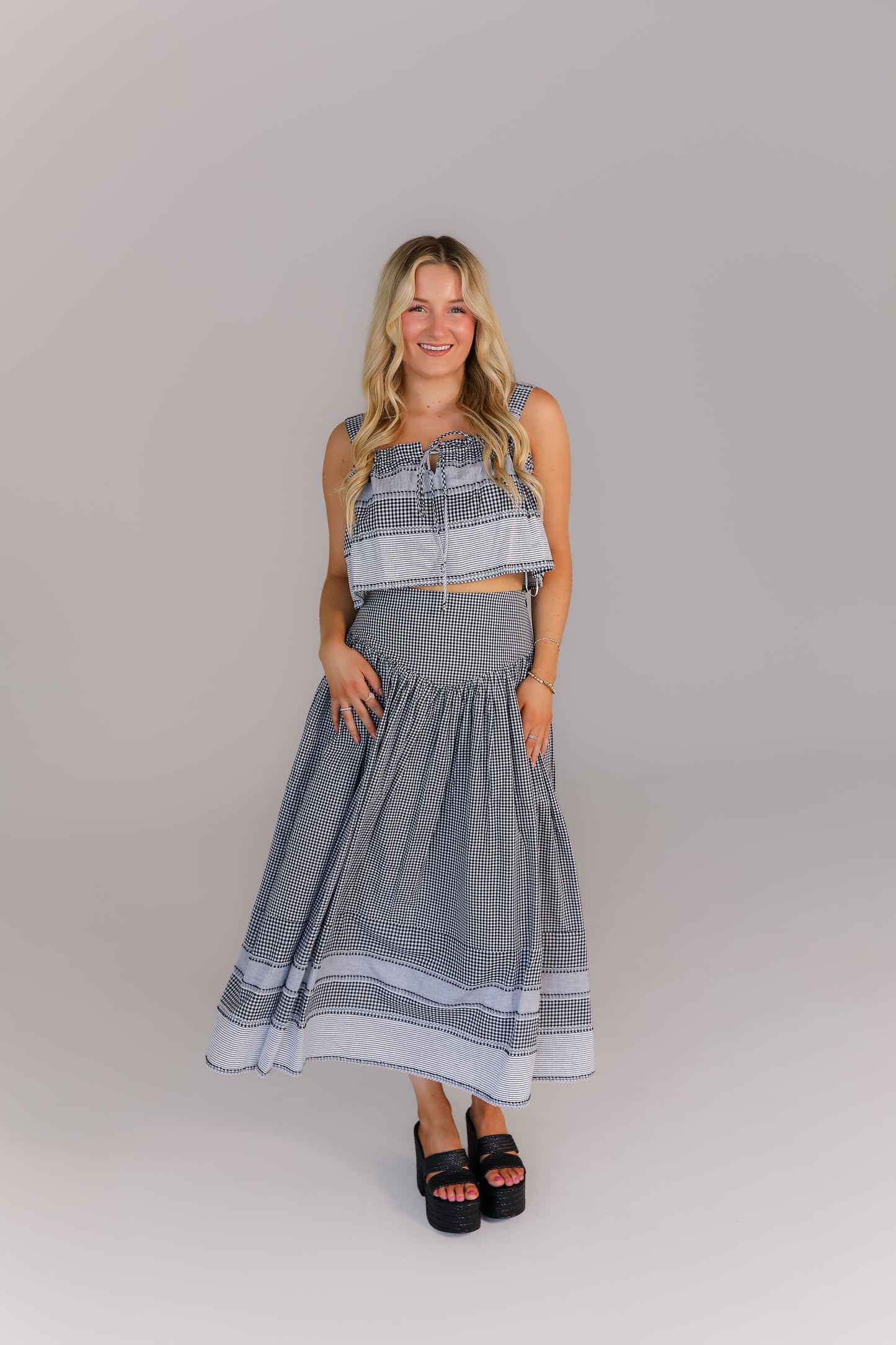 Model in gingham boutique set with smocked top and midi skirt