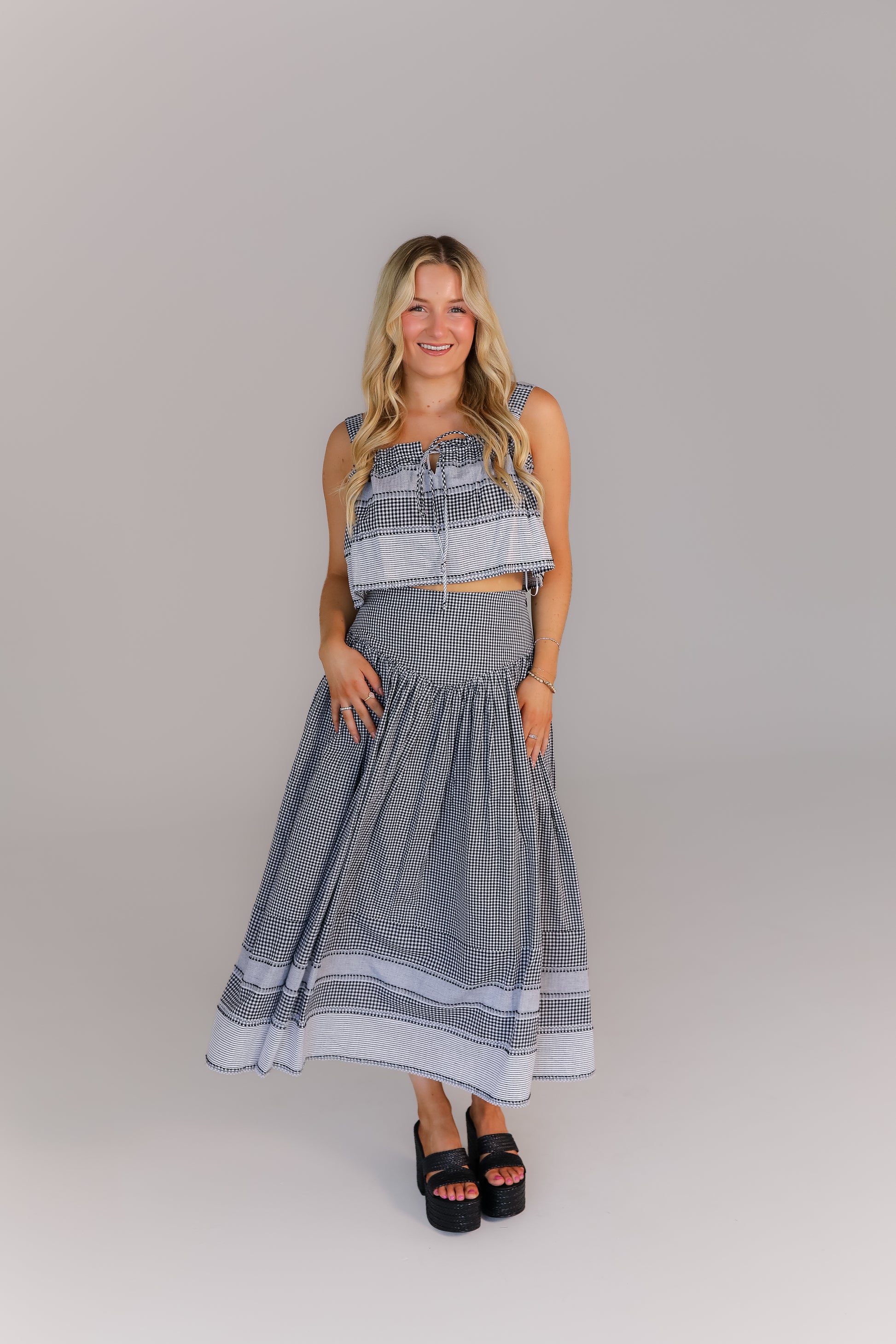 Model in gingham boutique set with smocked top and midi skirt