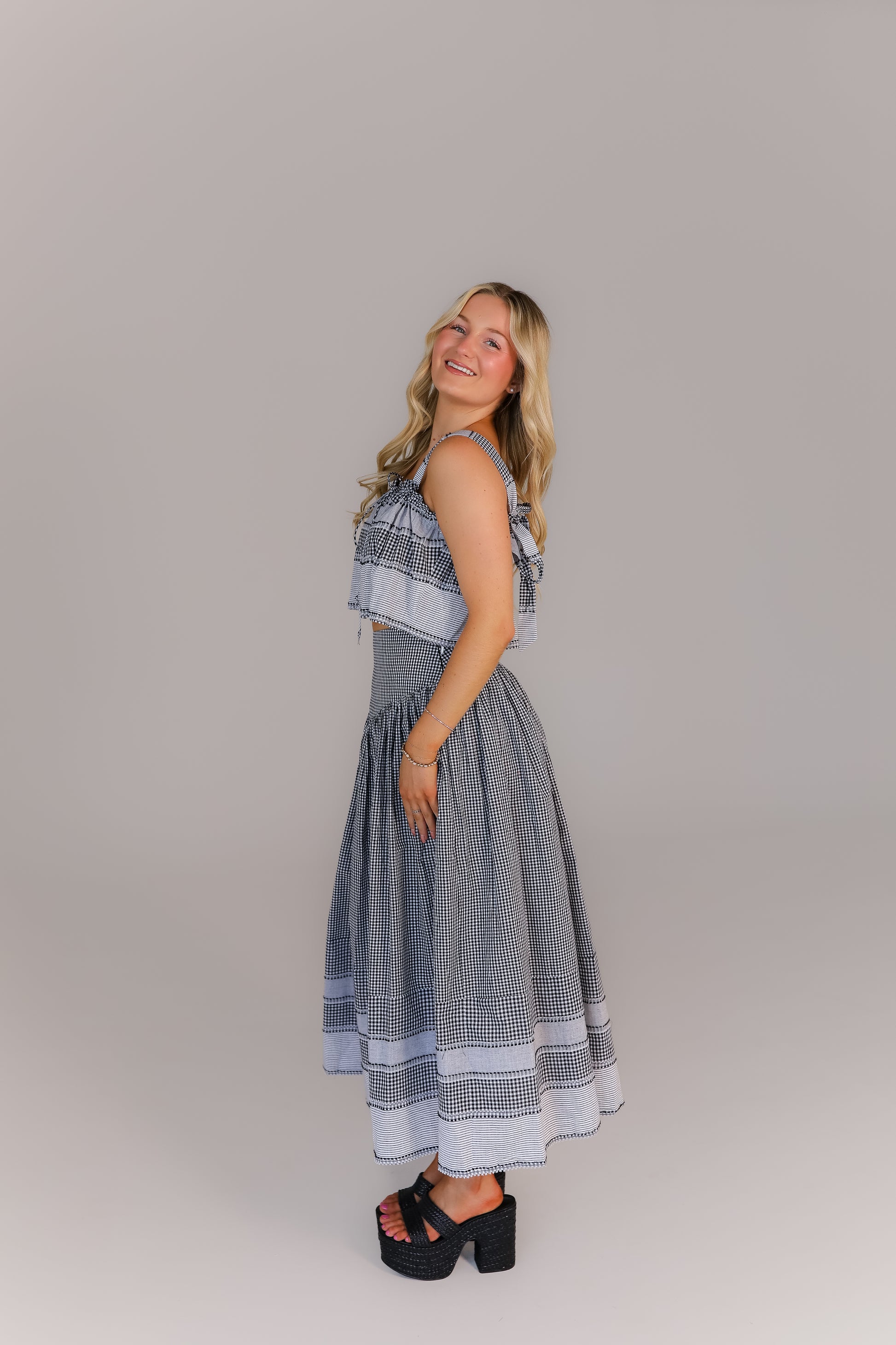 Side view of boutique crop top and midi skirt set in gingham print perfect for game day