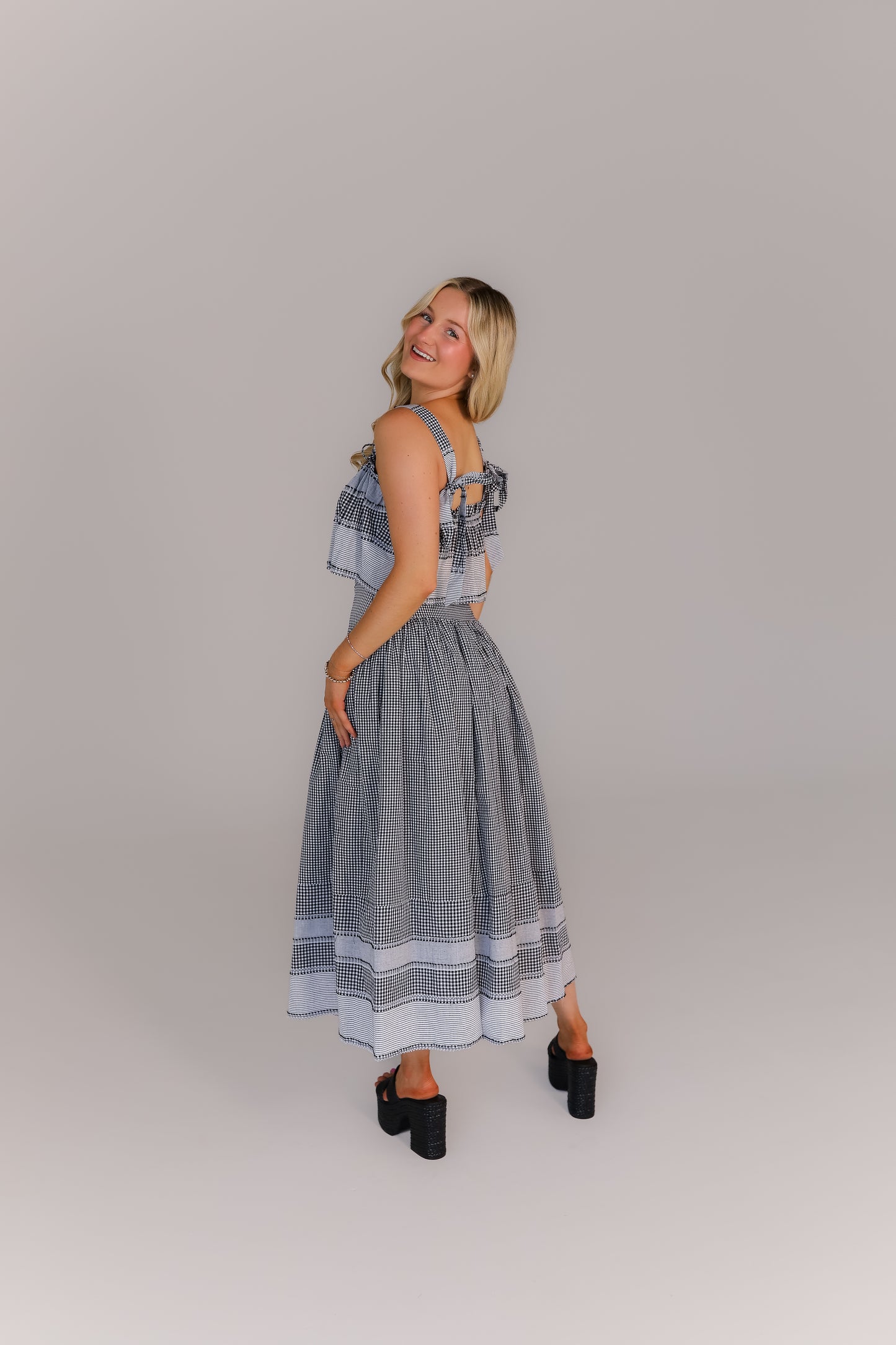 Back view of boutique crop top and midi skirt set in gingham print perfect for game day