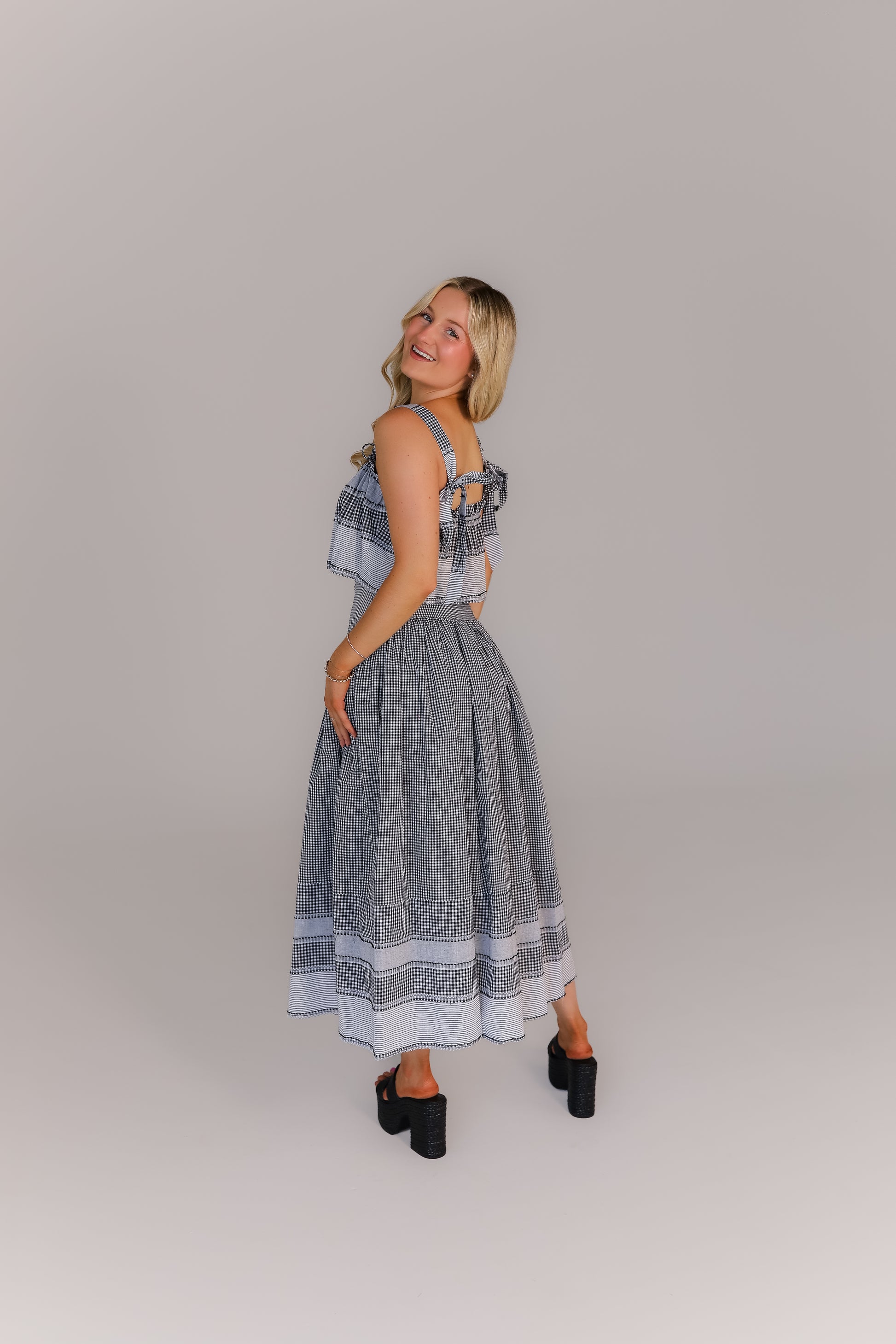 Back view of boutique crop top and midi skirt set in gingham print perfect for game day