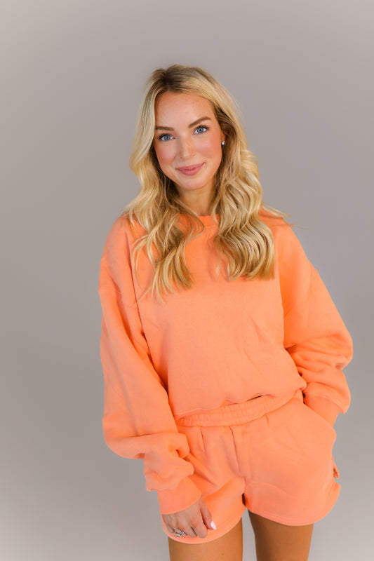 Cozy oversized peach sweatshirt and shorts outfit for class or errands