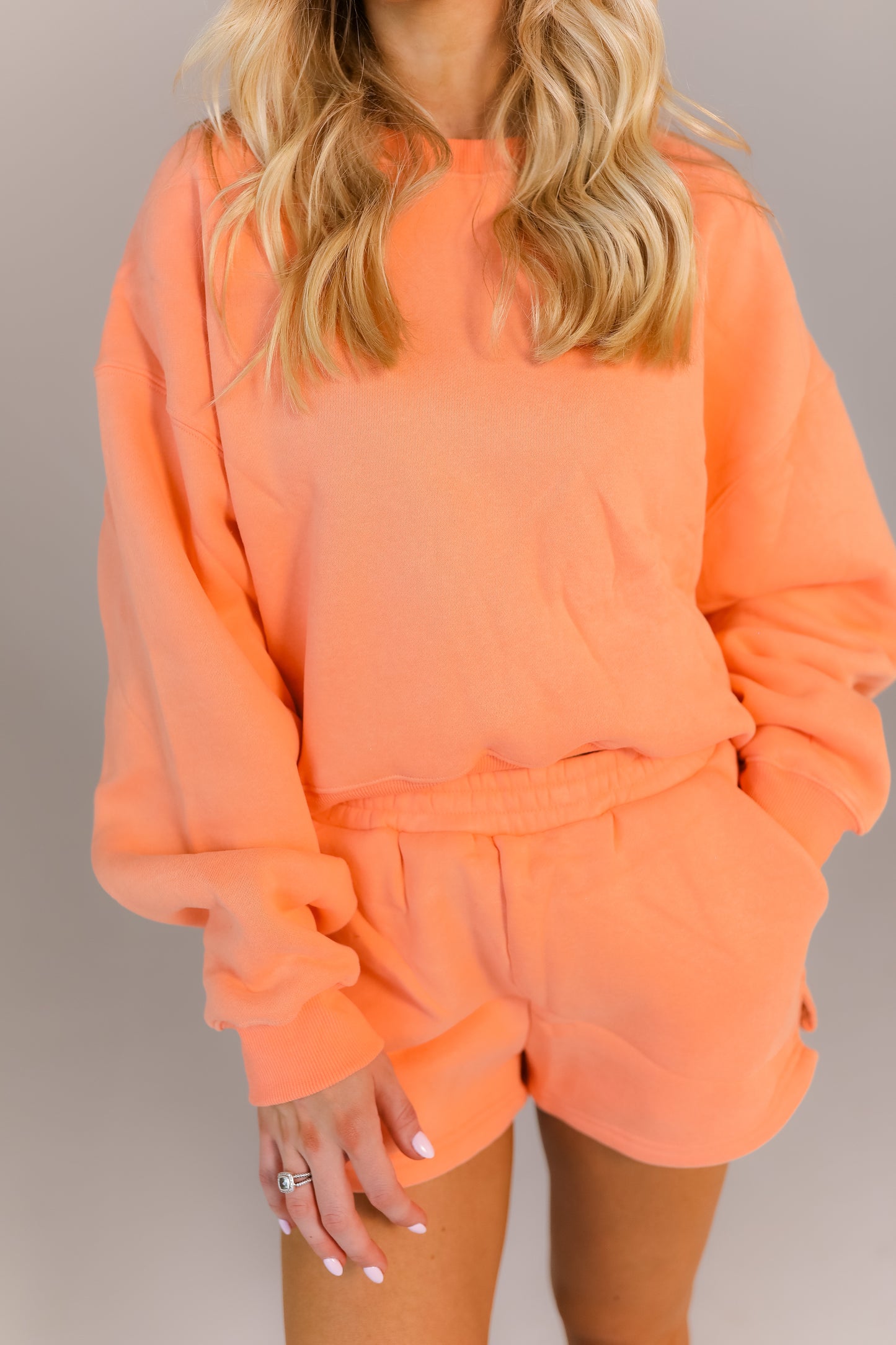 Cozy oversized peach sweatshirt and shorts outfit for class or errands