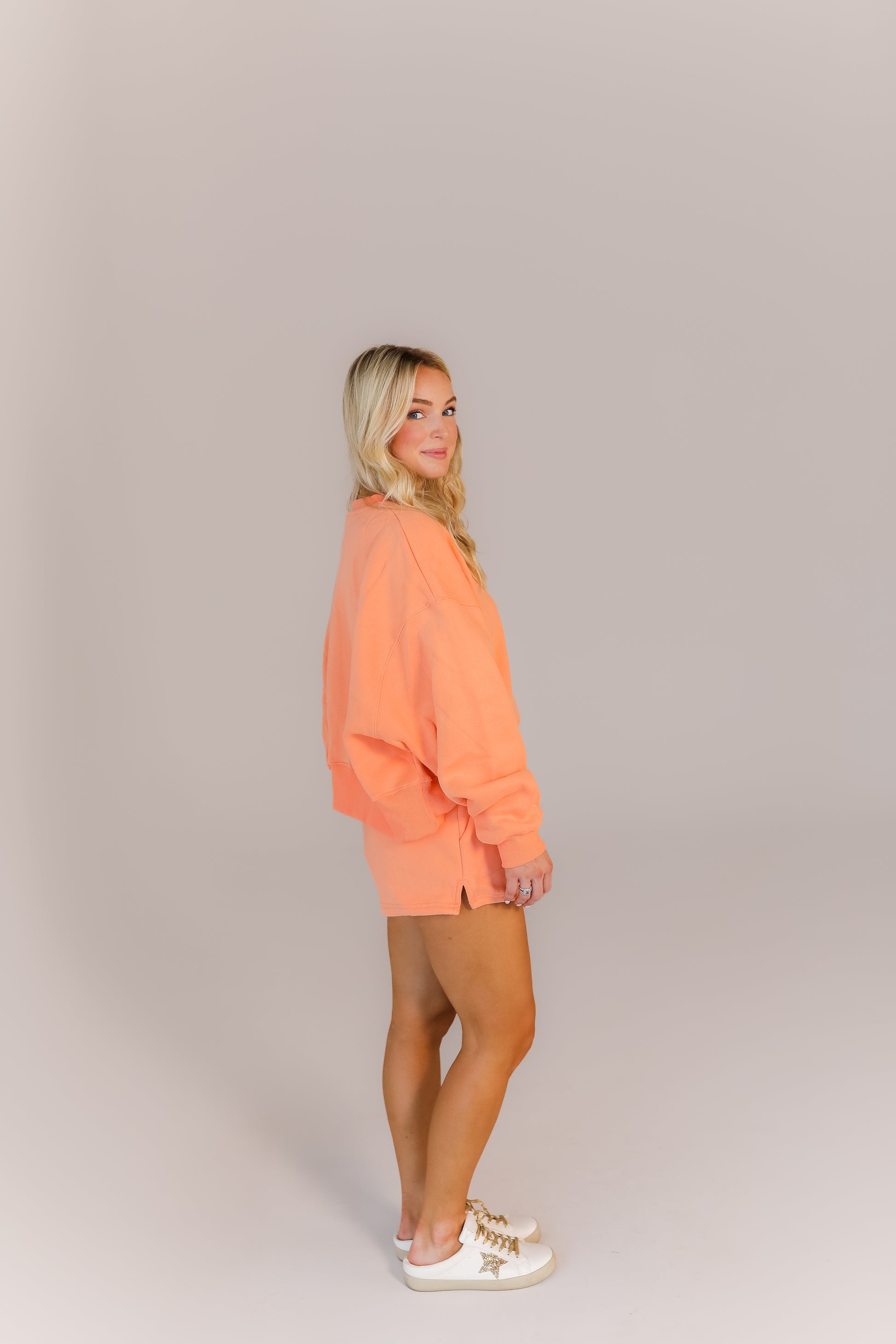 Cozy oversized peach sweatshirt and shorts outfit for class or errands