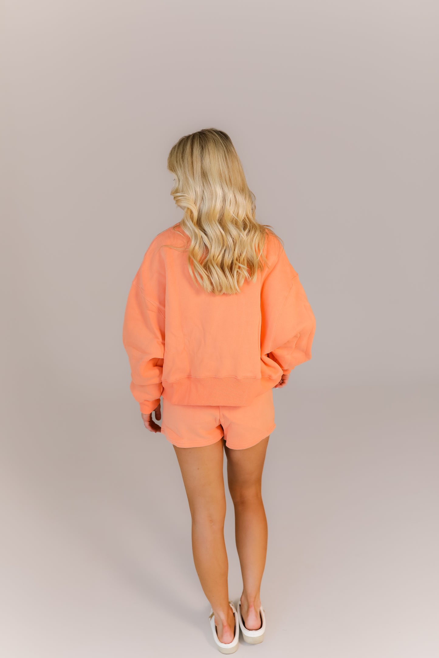 Cozy oversized peach sweatshirt and shorts outfit for class or errands