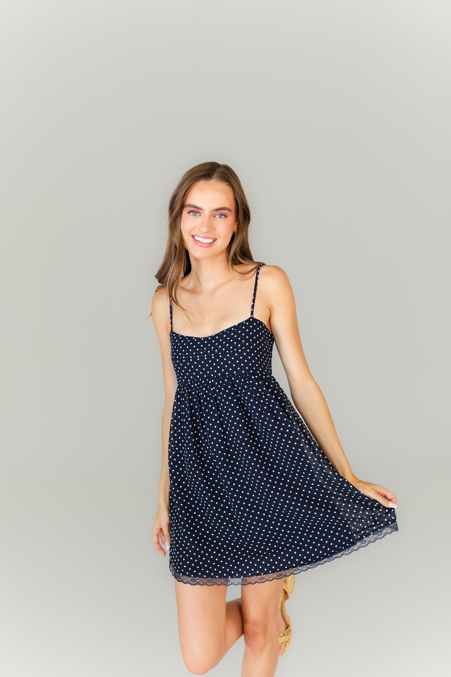 Women’s navy game day dress with thin straps and relaxed fit