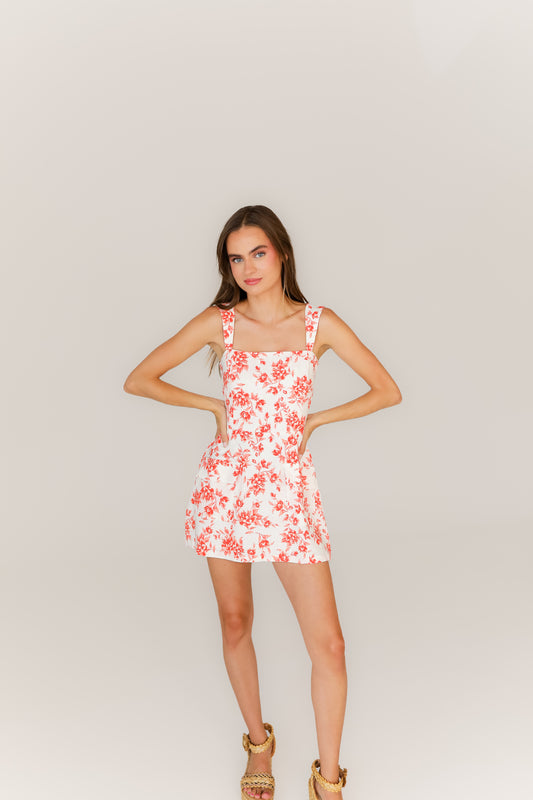 White mini dress with orange floral print and adjustable straps