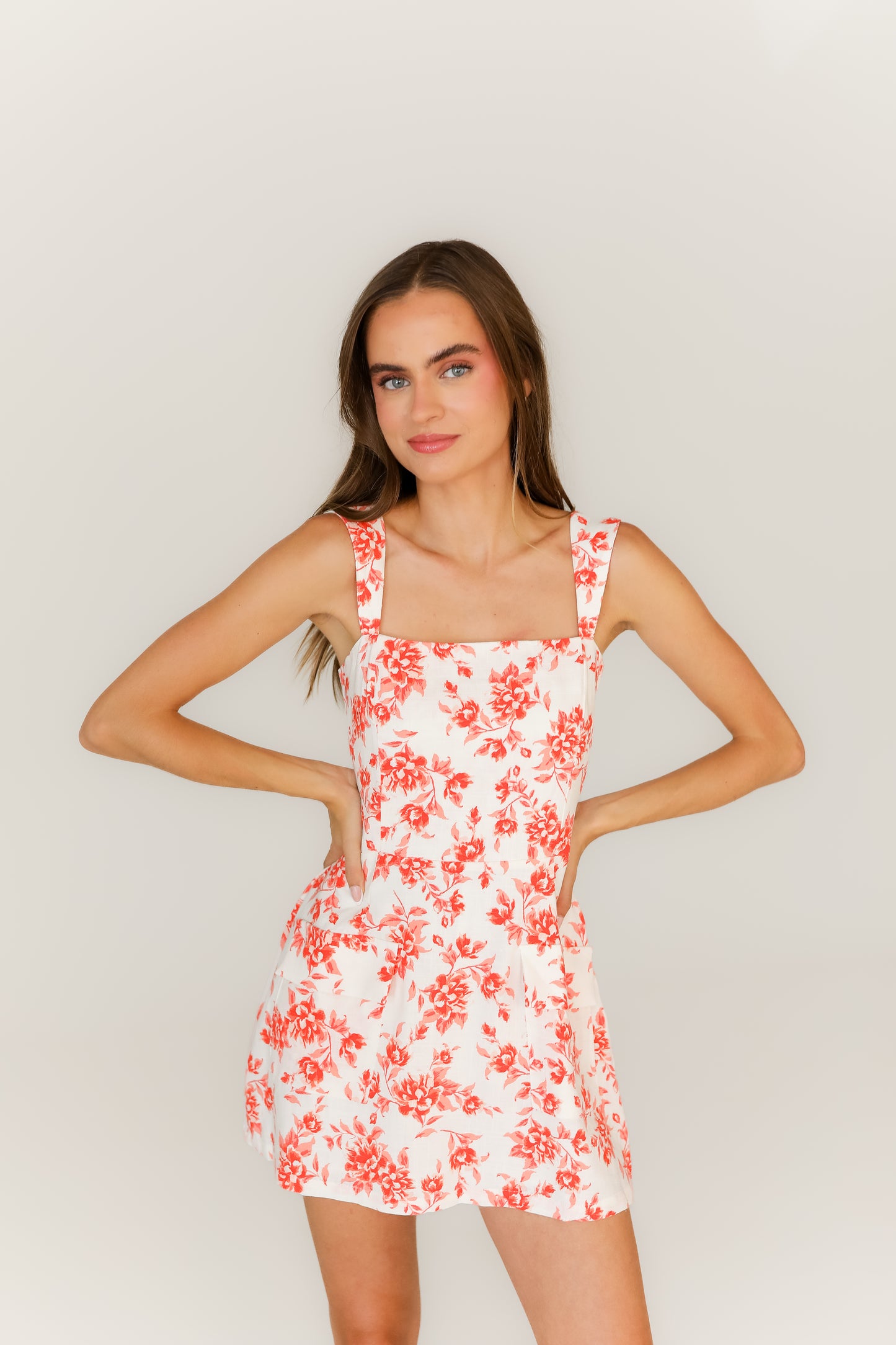 white and orange floral mini dress styled for spring, summer, or game day outfit