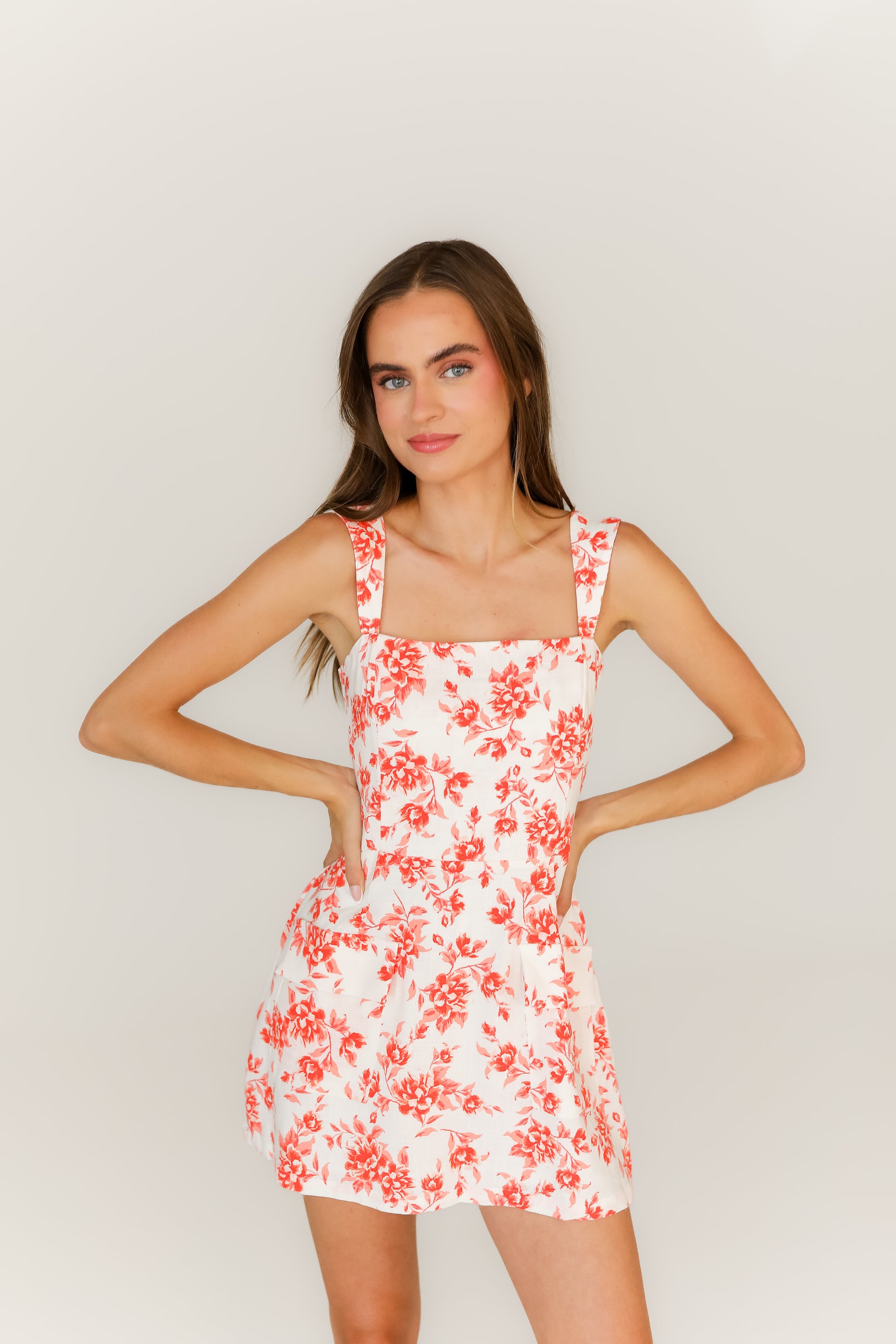 white and orange floral mini dress styled for spring, summer, or game day outfit