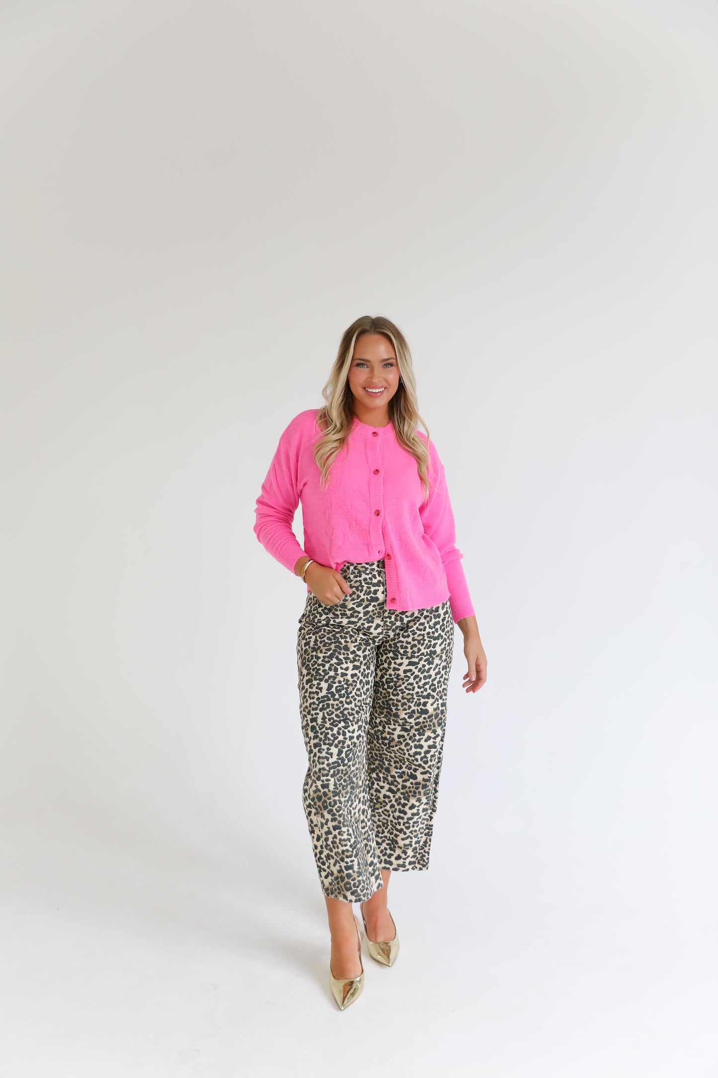 Pink cardigan paired with cheetah barrel jeans